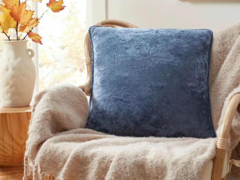 A blue decorative pillow on a chair 