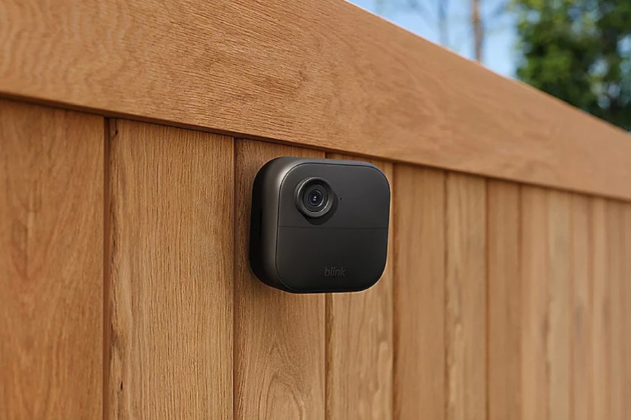 black camera attached to fence