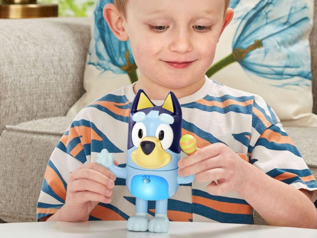 boy playing with shake it bluey