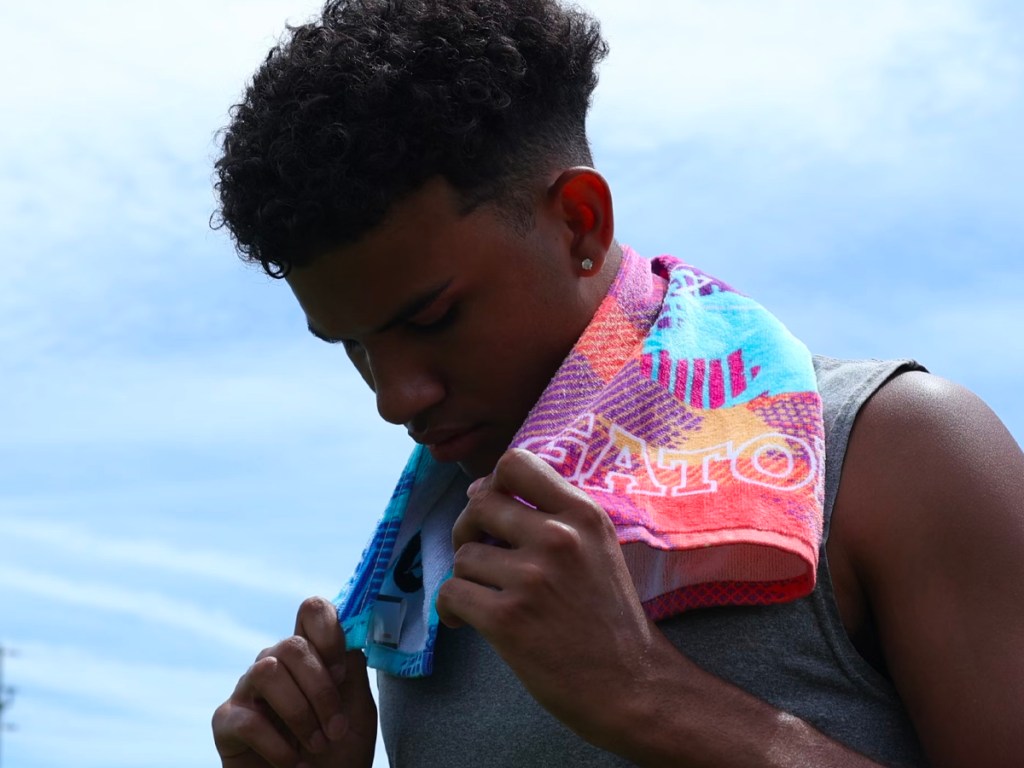 teen boy with multicolored gatorade towel around his neck