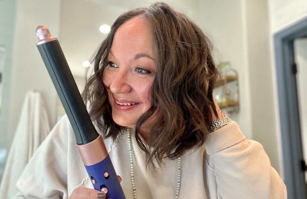 woman using dyson airwrap hair tool