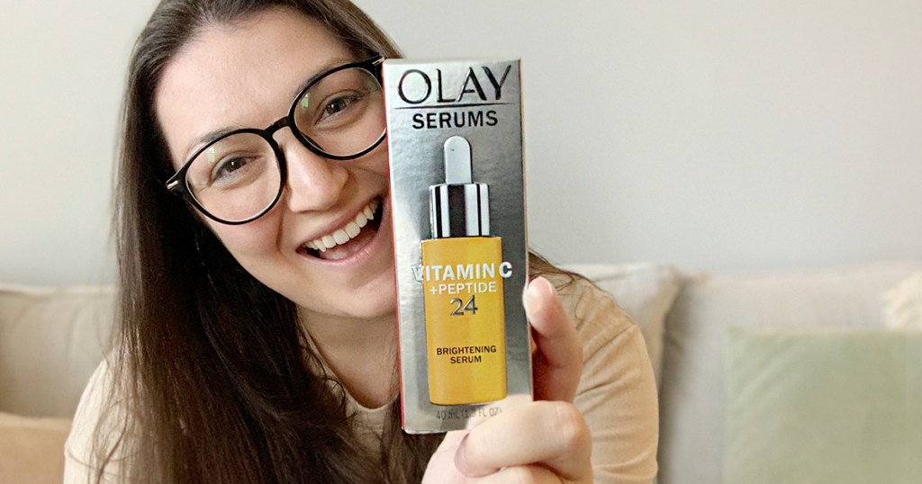 woman holding olay vitamin c serum