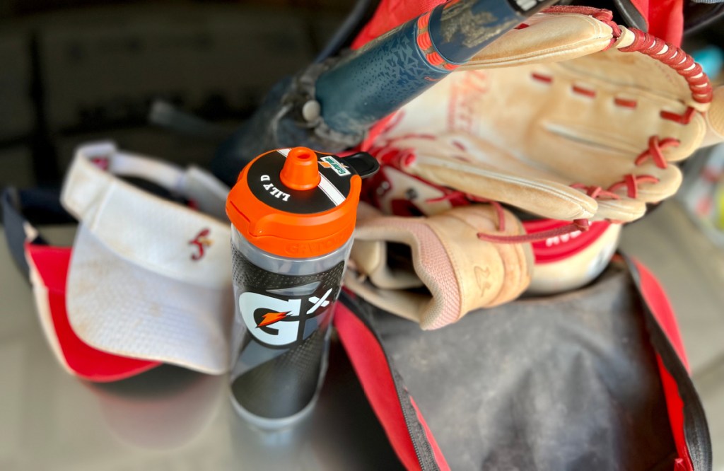 personalized gatorade gx water bottle in front of softball gear