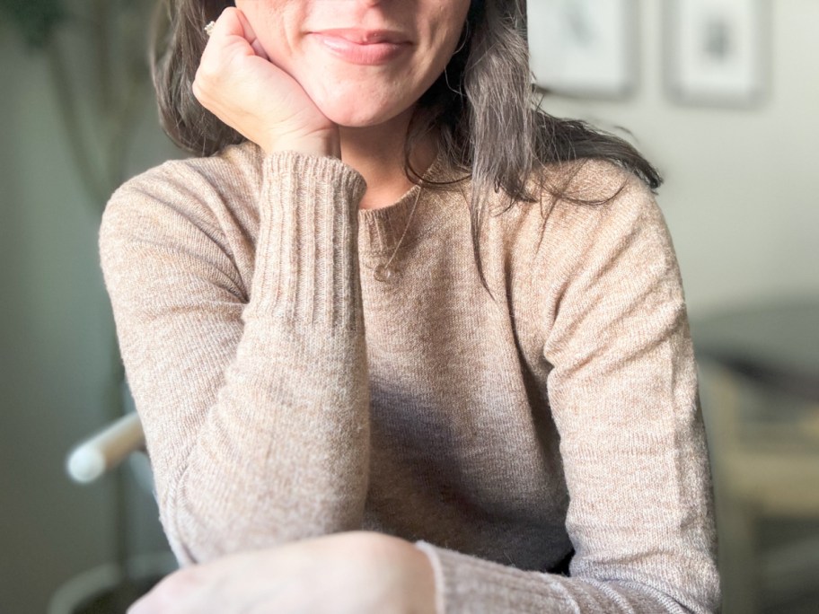 woman wearing tan sweater