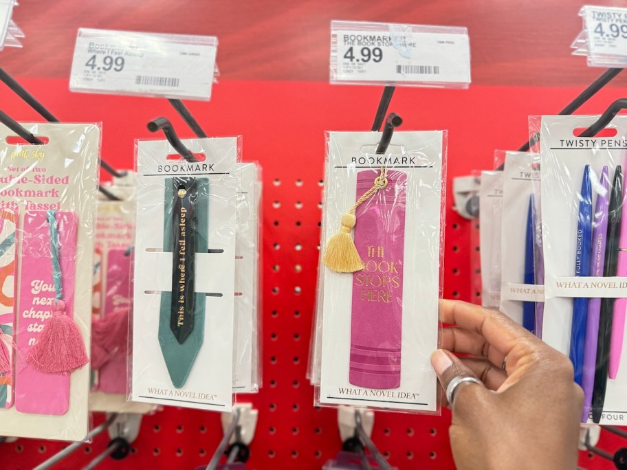 hand holding a pink bookmark on target store shelf