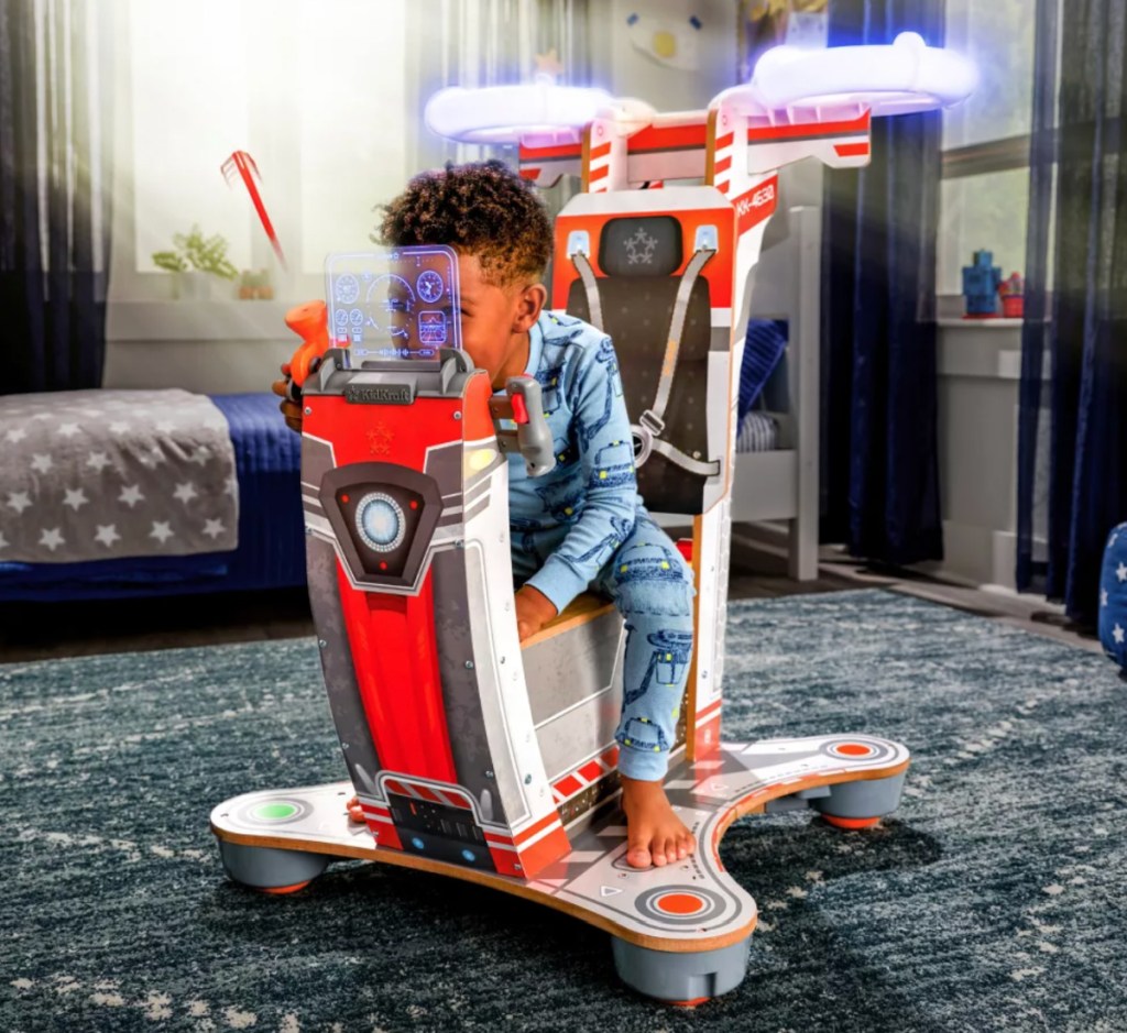 kid on kidkraft helicopter playset