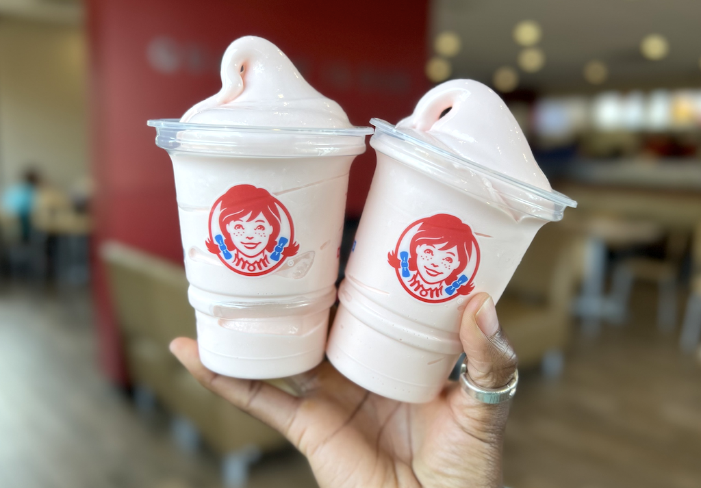 holding two Wendy's peppermint frosty treats