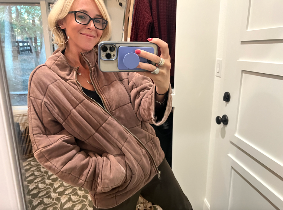 A woman wearing a brown jacket