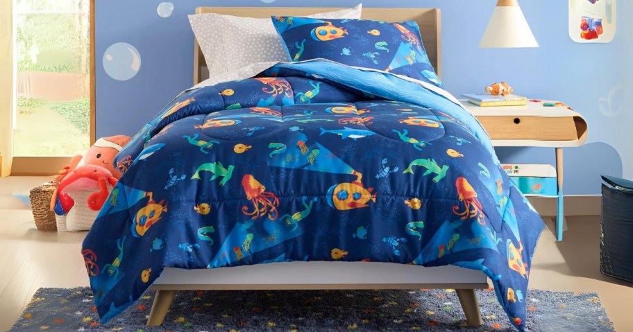 kid's bedroom with bed that has a blue comforter and sham with ocean animals and scenery on it