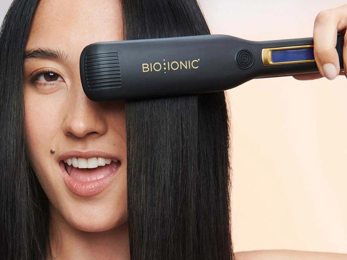 Woman using a Bio Ionic Flat Iron