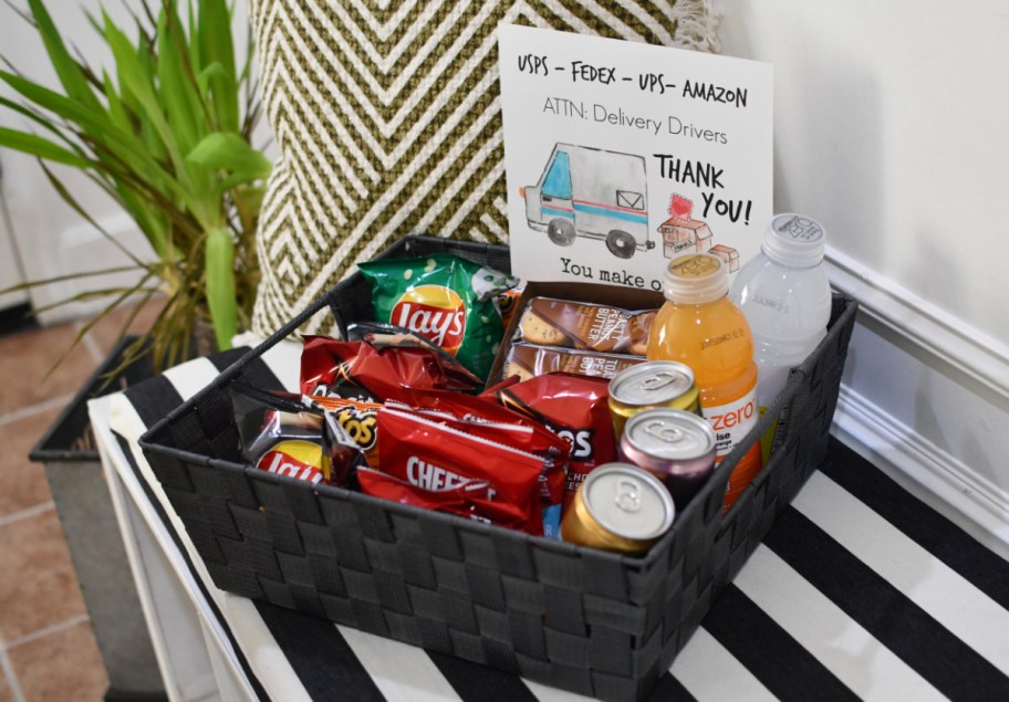 A delivery driver care package with thank you note sitting on a front porch