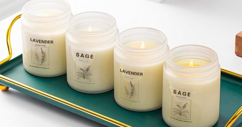 Lavender and sage aromatherapy soy wax candles lined up in a row on a green tray
