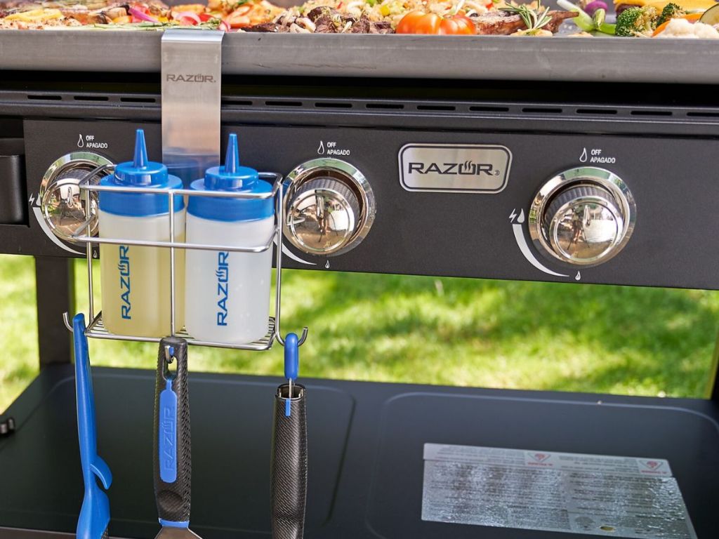 A griddle with a Mr BBQ Squuze bottle holder caddy attached to it