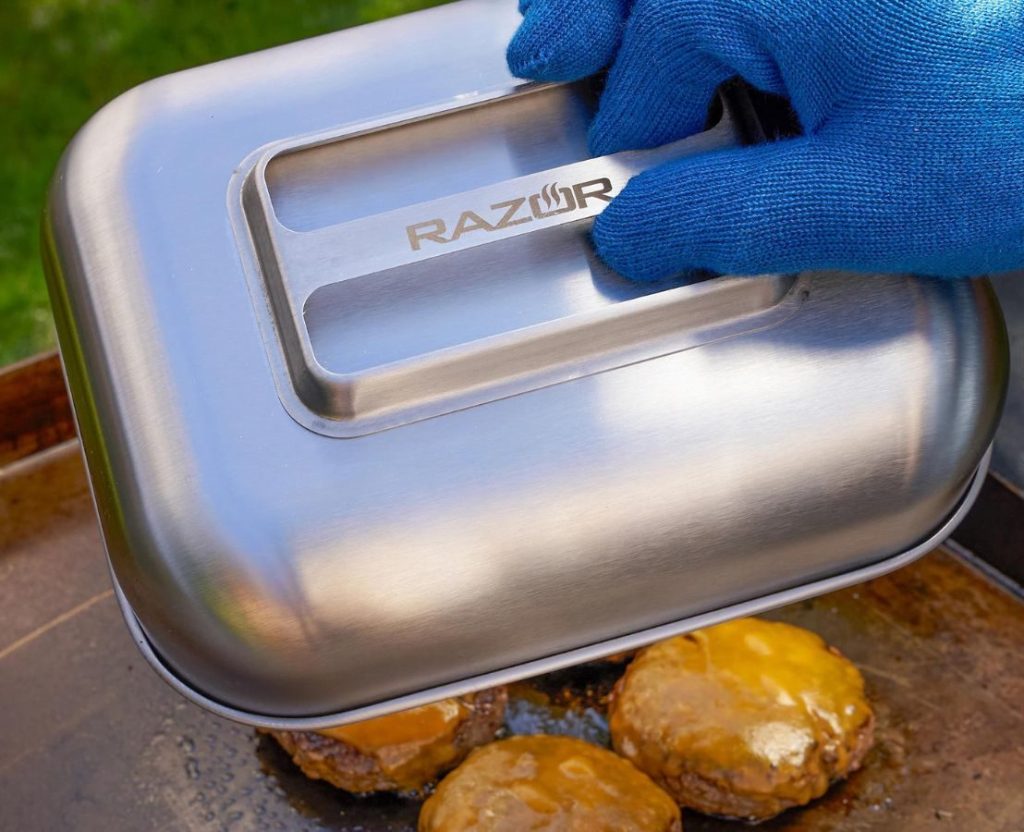 Hand holding a Mr. BBQ basting dome