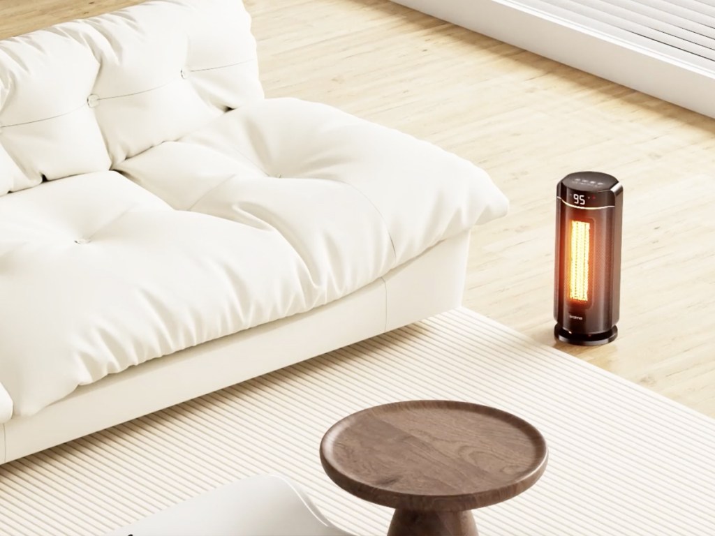 portable space heater on floor near couch and coffee table