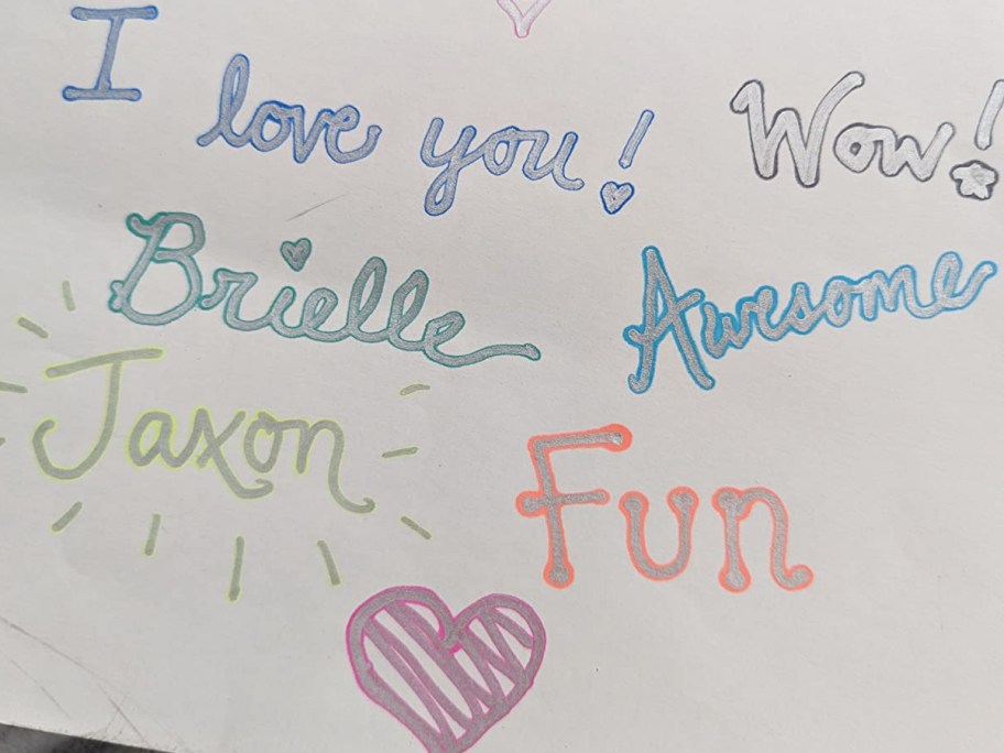 doodles and names on piece of paper in metallic outline marker
