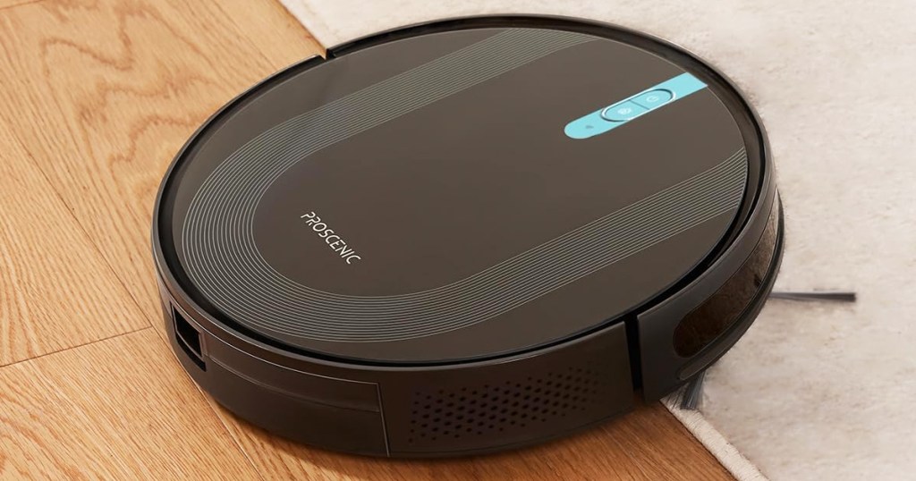 black robot vacuum going from wood floor to carpet