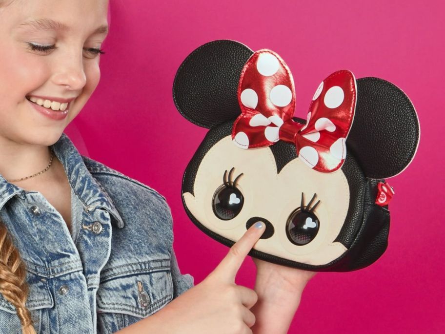 Purse Pets Disney Minnie Mouse Shoulder Bag being poked by a little girl 