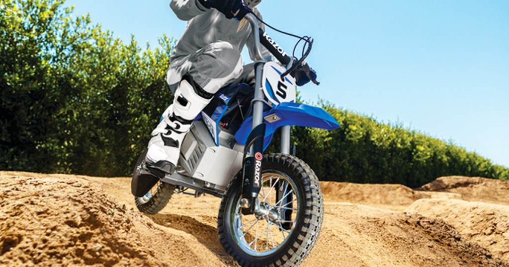 kid riding a blue razor brand dirt bike