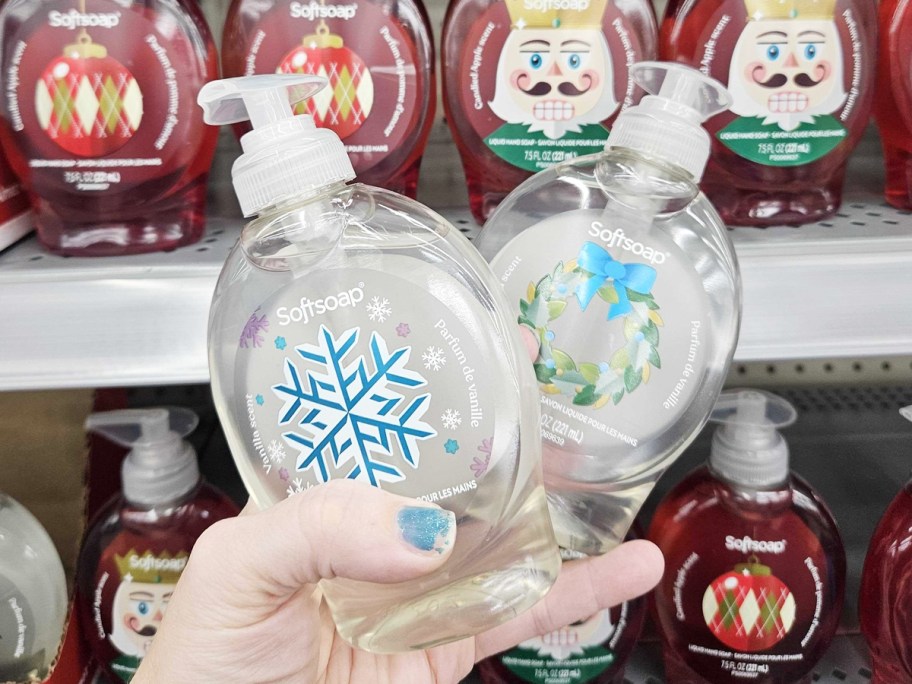 hand holding up two christmas Softsoap hand soaps in store