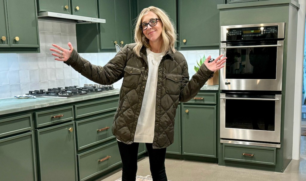 Woman standing in green kitchen, wearing green quilted jacket from oprah’s favorite things 2023