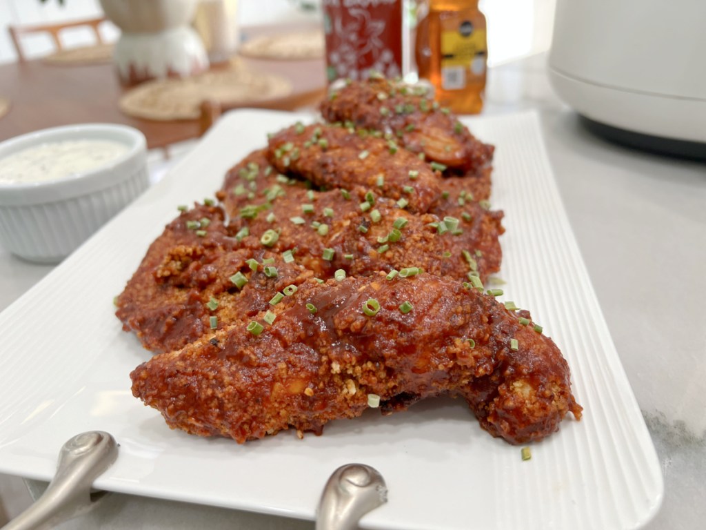 plate with honey sriracha chicken tenders on a plate