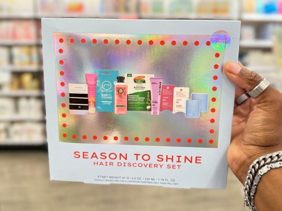 hand holding a blue box with hair care item pictures on it that's a Season to Shine Hair Styling Discovery Set