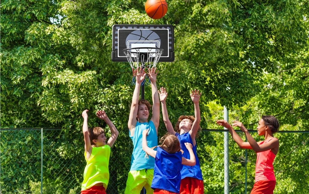 happy kids playing basketball outdoors