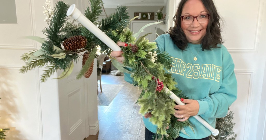 woman holding a tension rod and garland