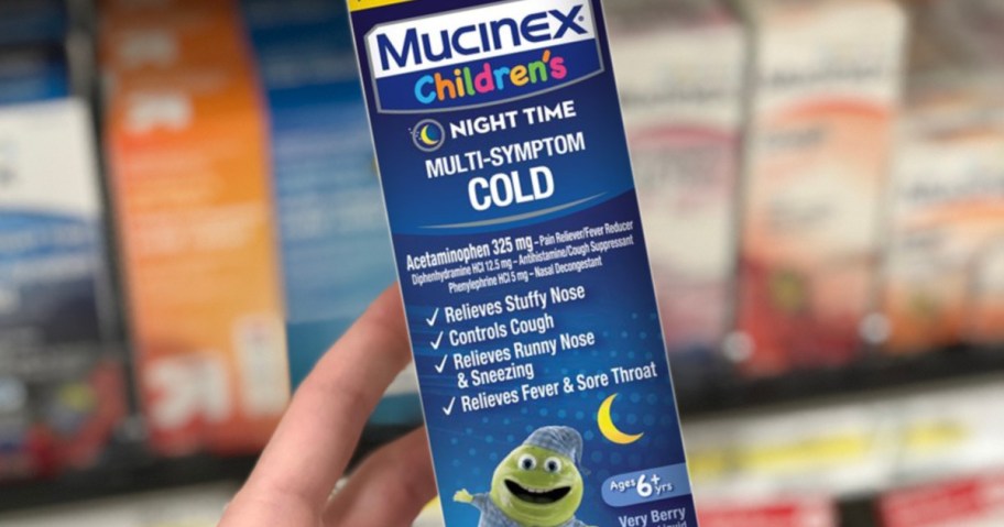 Hand holding a box of children's Mucinex