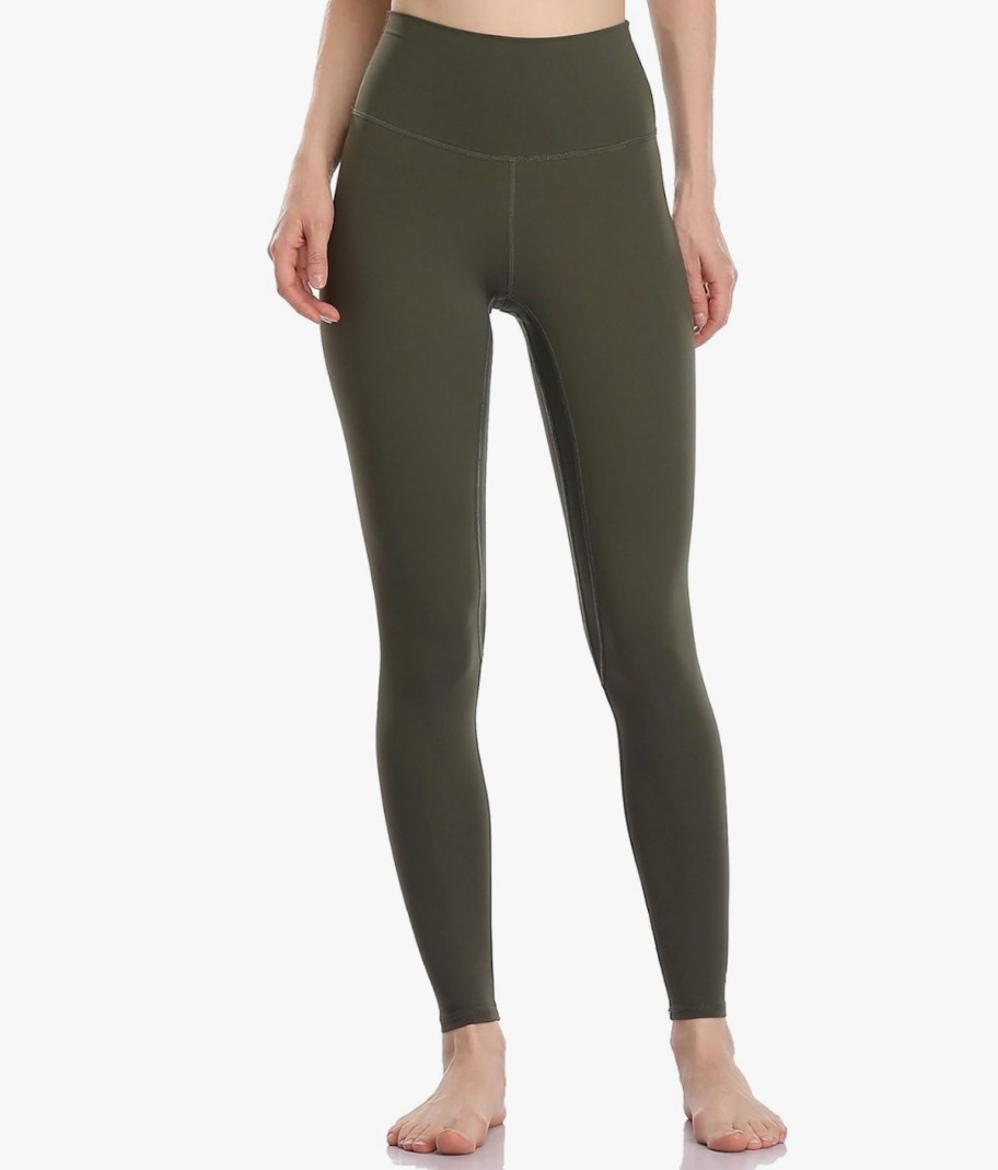 stock photo of woman posing in green leggings