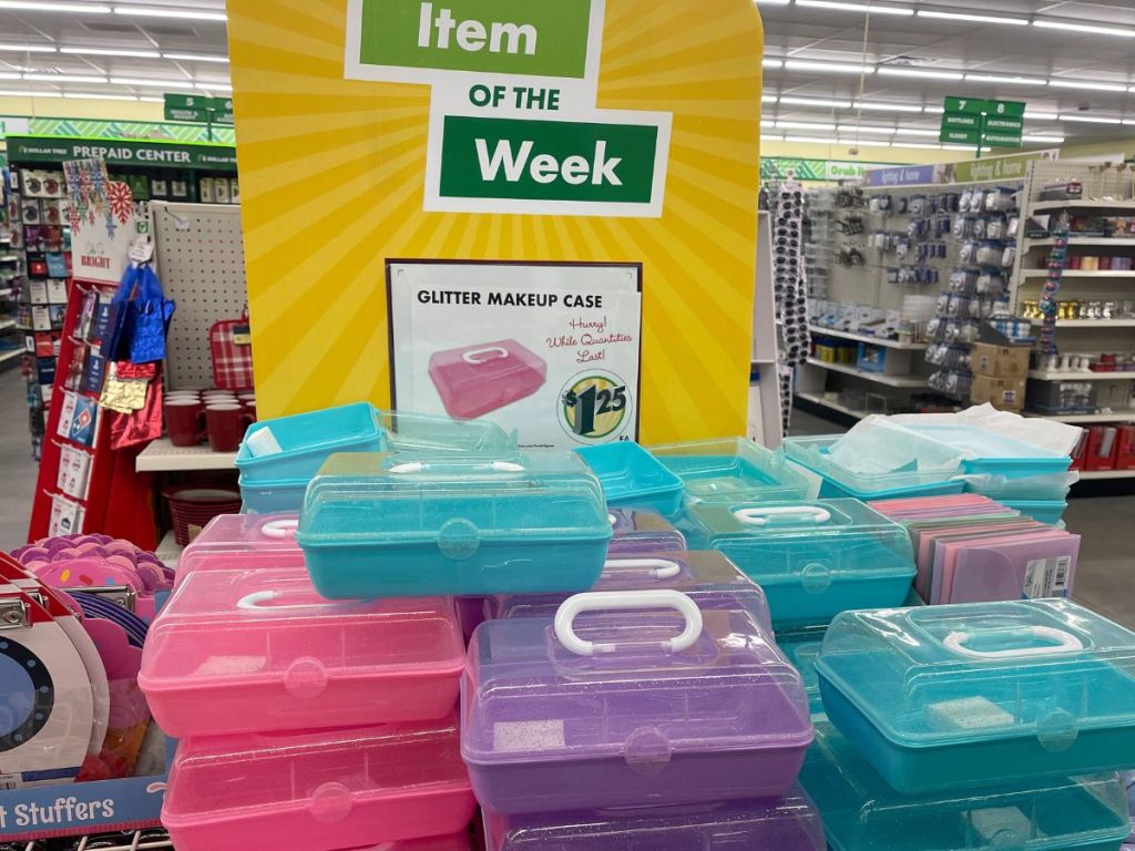 a stack of glittery plastic makeup cases in a dollar tree store.