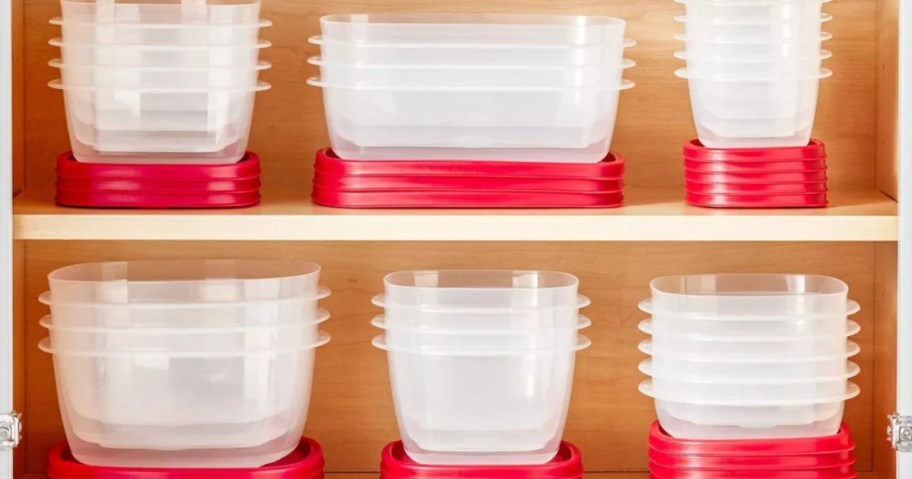 clear Rubbermaid containers with red lids stacked on shelves in a kitchen cabinet