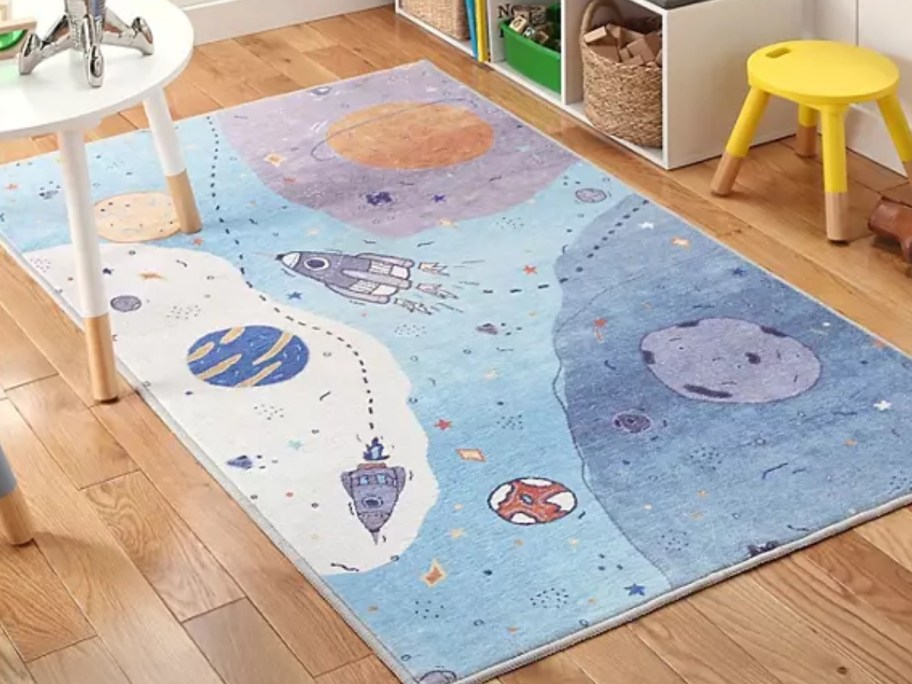 a kids activity rug with an outerspace design in a playroom