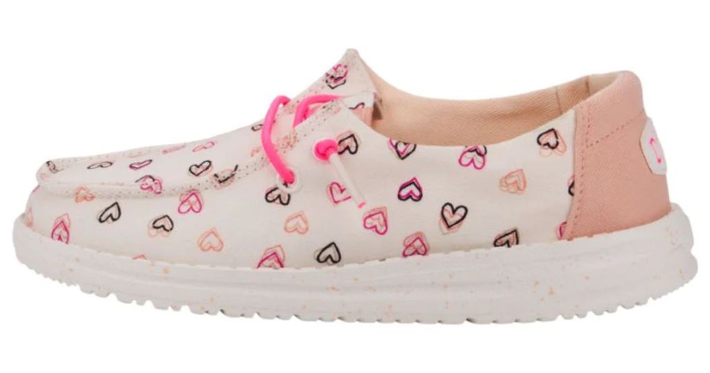 white youth Hey Dude shoe with pink and red double hearts and pink laces