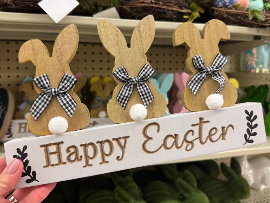 Hand holding a Hobby Lobby Happy Easter Bunnies Wood Decor