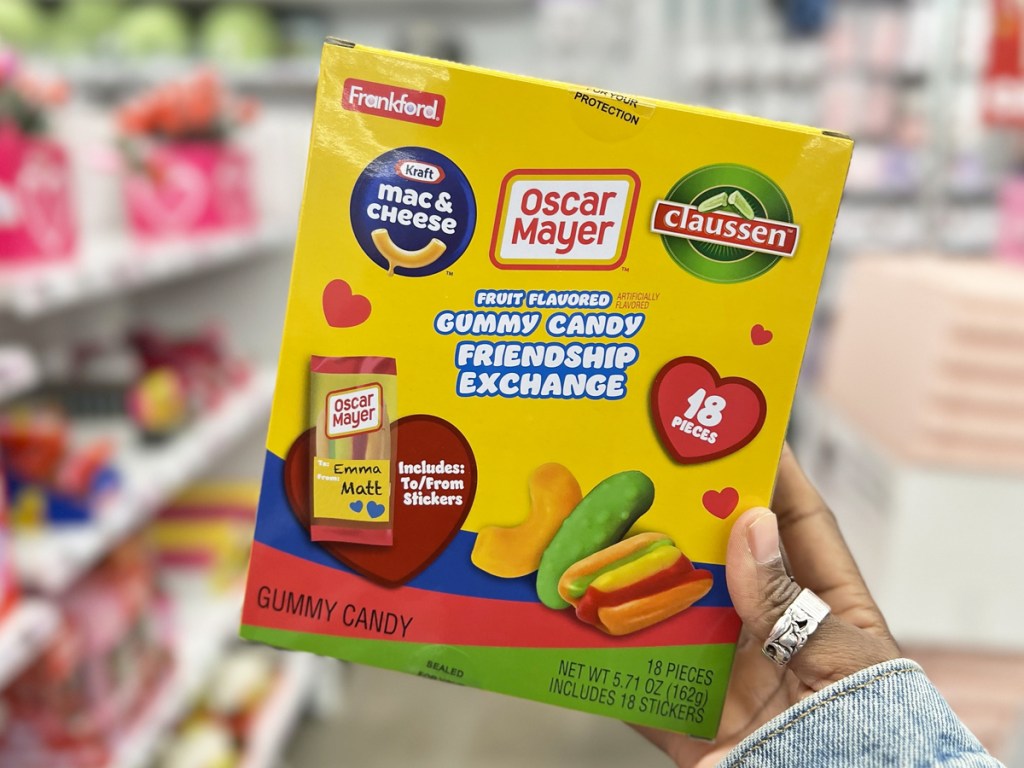 hand holding up a box of Kraft, Oscar Mayer, & Claussen Gummy Candy Friendship Exchange valentine's candies