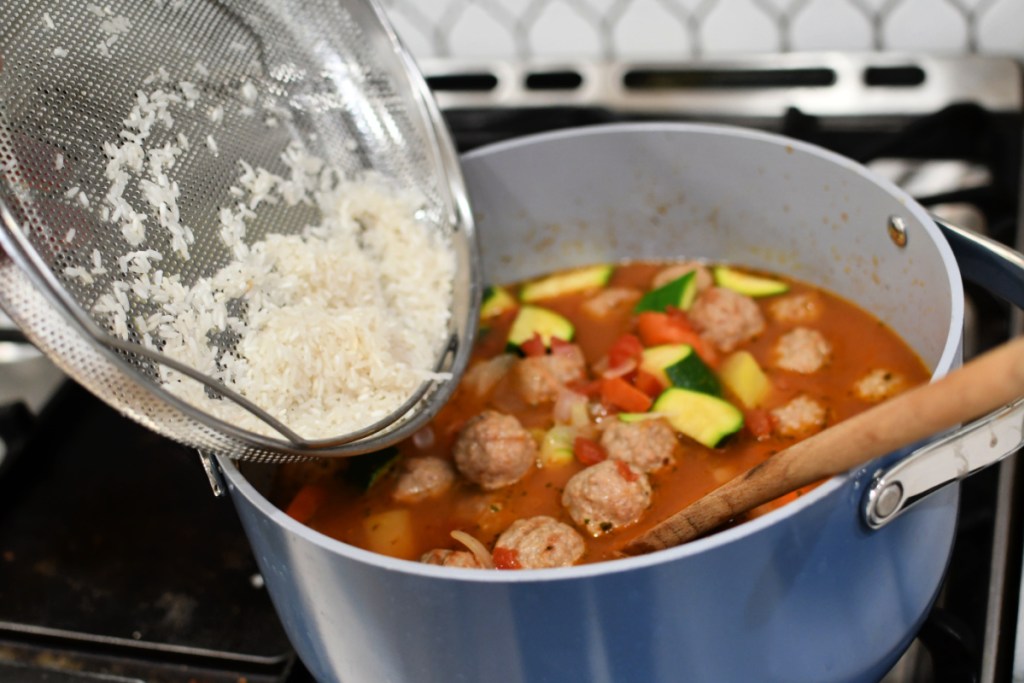 adding rice to soup