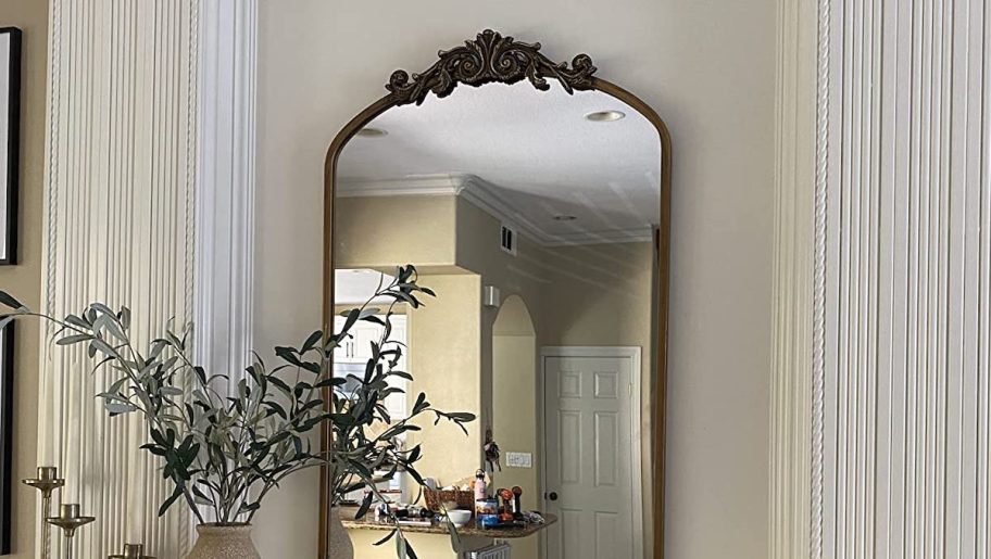 ornate mirror above white mantle 
