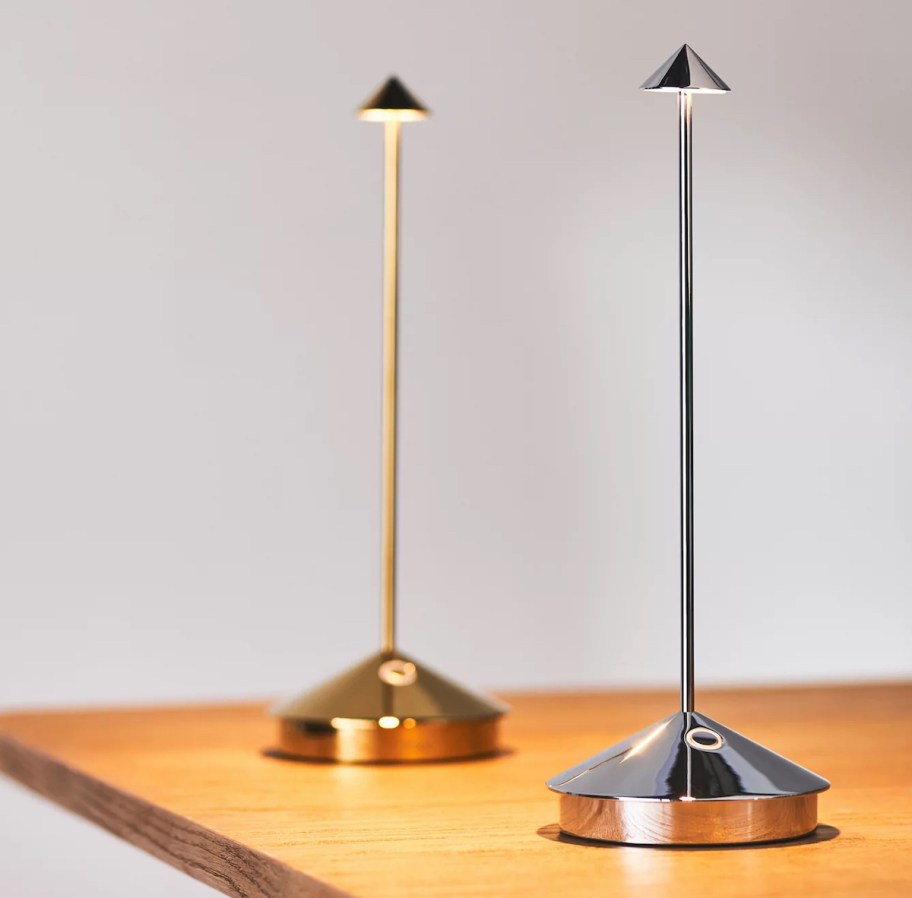 gold and silver chrome table lamps on wood table