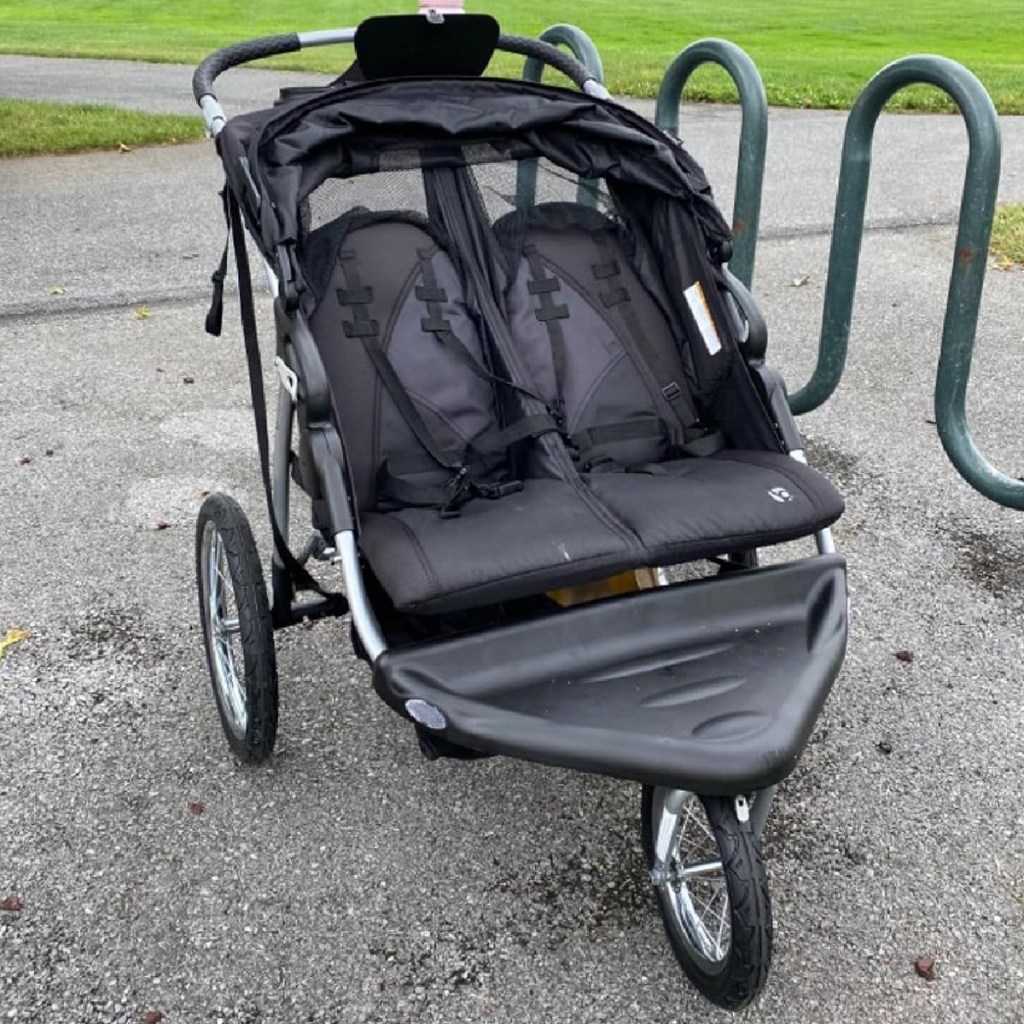 empty double jogging stroller outside