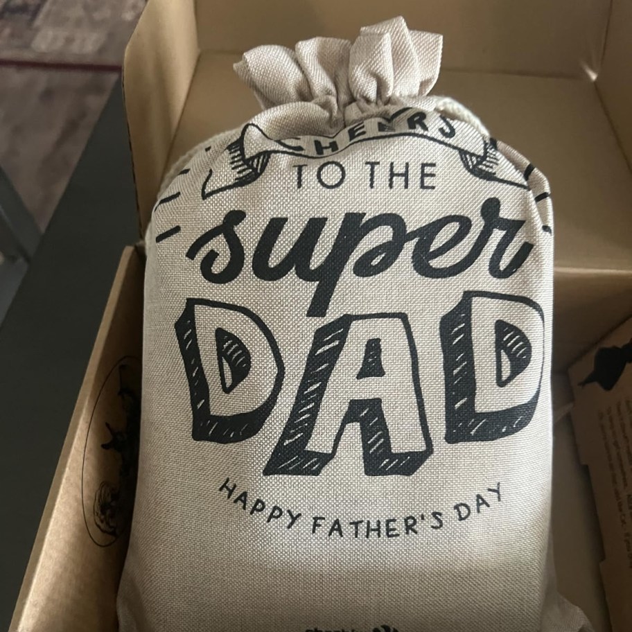 burlap gift bag that reads "to the super dad"
