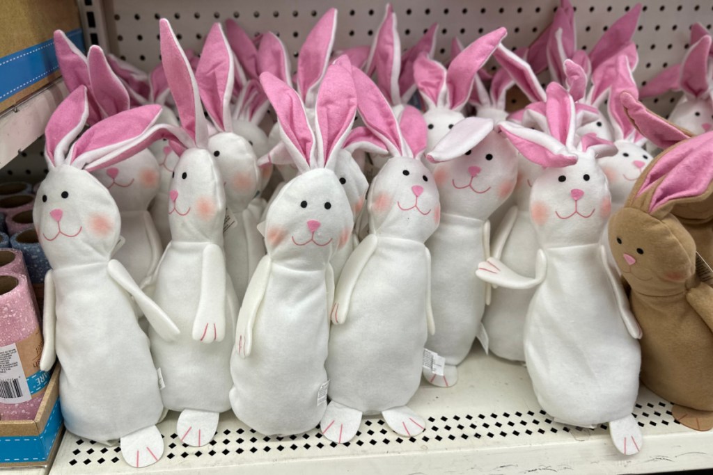 white and brown plush bunnies on shelf at dollar tree