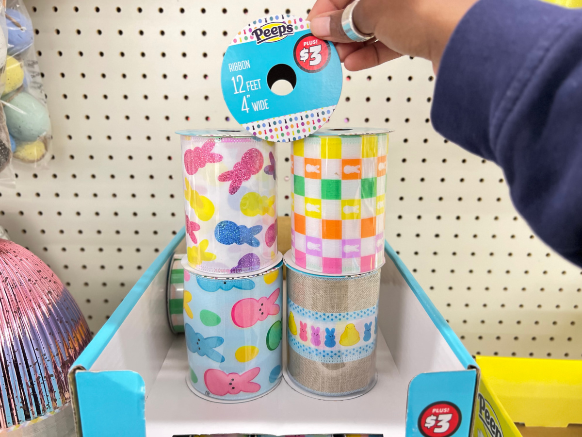 hand grabbing peeps ribbon in store