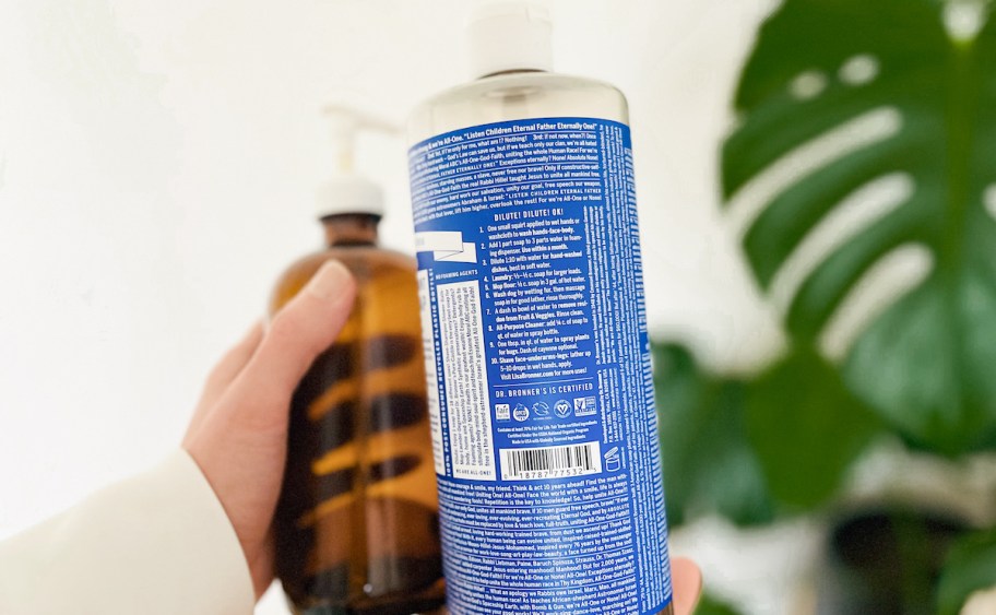 hand holding a bottle of dr bronners castile soap