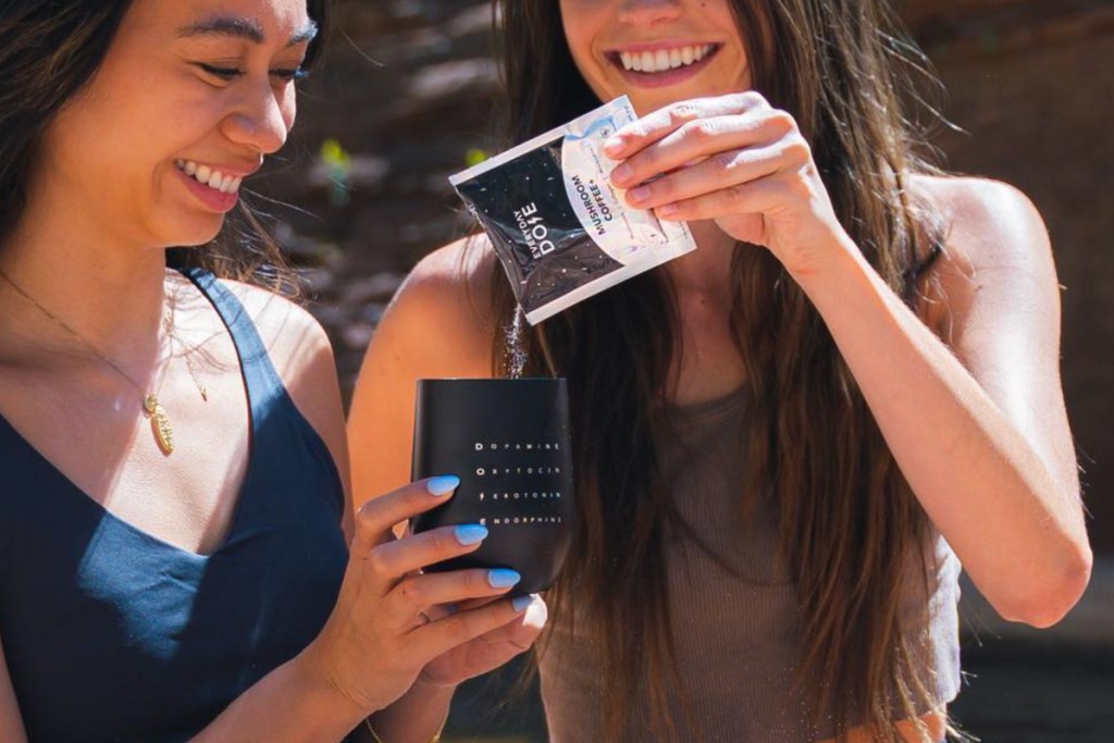 girl pouring coffee into another girls cup