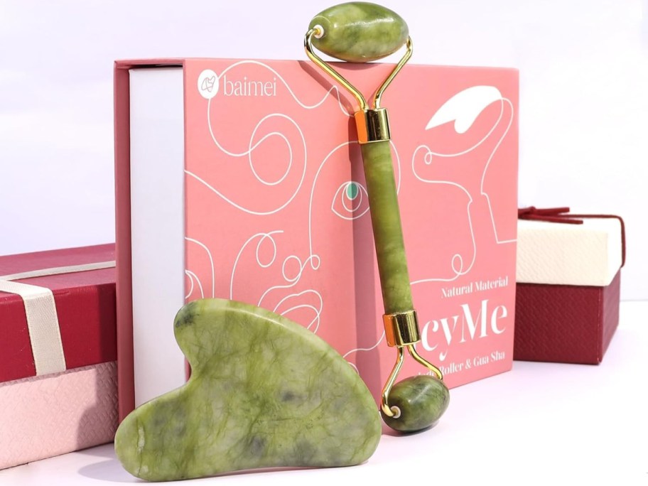 gua sha and jade roller in front of a pink box