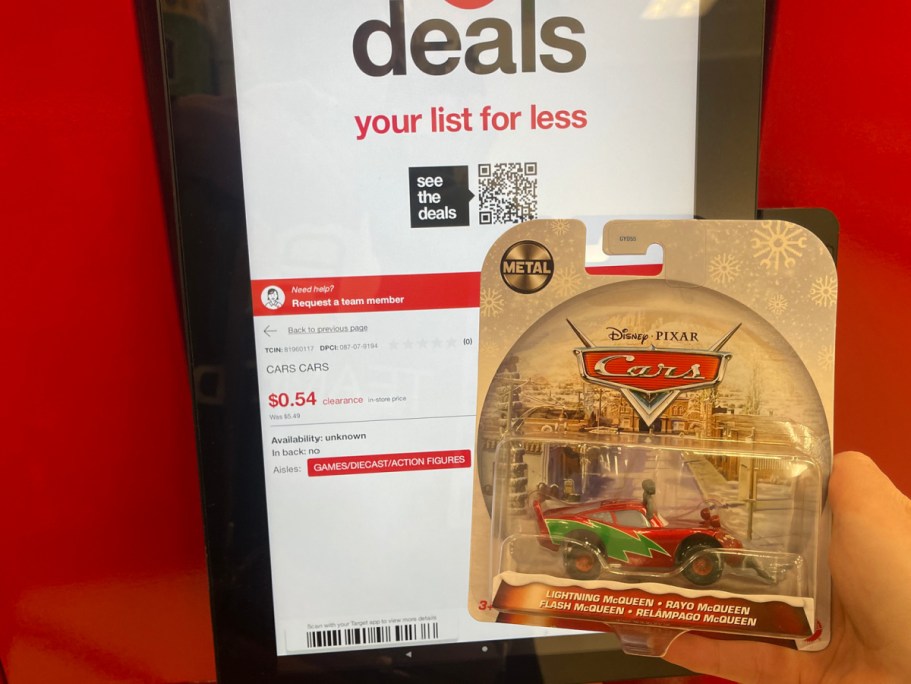 hand holding Cars Car in front of the price check at Target