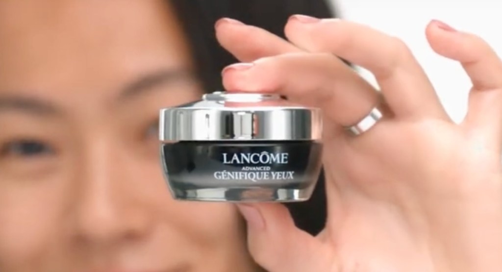 hand holding lancome eye cream unclose to the camera