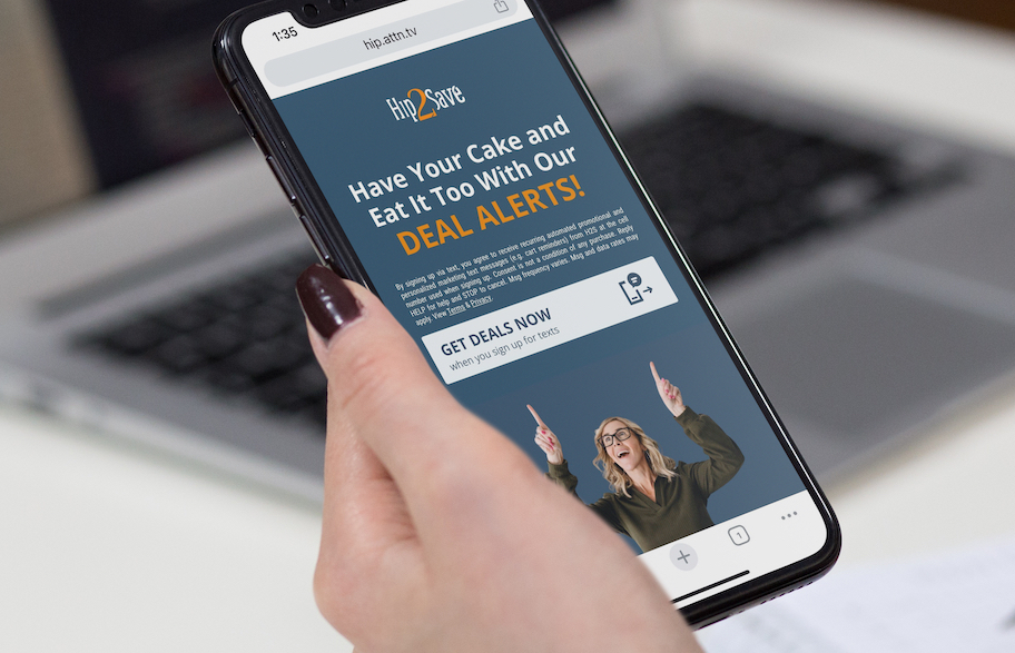 hand holding phone with hip2save text alerts sign up on screen